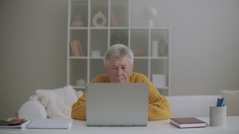 Senior-mature-older-woman-typing-a-message-on-the-keyboard-online-webinar-on-laptop-computer-remote-working-or-social-distance-learning-from-home.-60s-80s-businesswoman